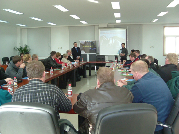 gusets hear a briefing of Beijing Dairy Cattle Center